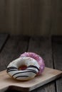 Glazed mini donuts on wooden background