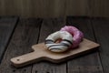 Glazed mini donuts on wooden background