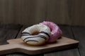 Glazed mini donuts on wooden background