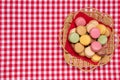 Pastries, desserts and sweets.  Top view of multicolord original french macaroon cookies are arranged in a basket on a red Royalty Free Stock Photo
