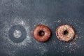 Pastry background. Chocolate donut or doughnut on black table top view. Flat lay. Copy space for text.