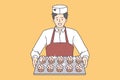 Pastry baking worker with cupcakes tray. Royalty Free Stock Photo