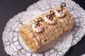 Pastry cake biscuit roulade with whipped cream and chocolate scrolls