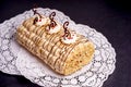 Pastry cake biscuit roulade with whipped cream and chocolate scrolls