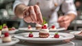 A pastry chef arranging edible flowers on a stunning wedding cake Royalty Free Stock Photo