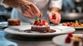 A pastry chef arranging edible flowers on a stunning wedding cake Royalty Free Stock Photo