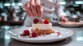 A pastry chef arranging edible flowers on a stunning wedding cake Royalty Free Stock Photo