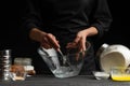 A pastry chef or baker prepares the dough by whipping with a spoon, for sweets, rolls or Italian pizza or pasta. Freeze in motion Royalty Free Stock Photo