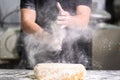 Pastry Chef clapping his hands with flour while making dough Royalty Free Stock Photo