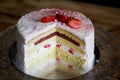 The pastry chef cut the cake. Strawberry yogurt cake. Consists of butter sponge cakes,covered with cream-based live Royalty Free Stock Photo