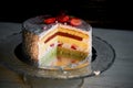 The pastry chef cut the cake. Strawberry yogurt cake. Consists of butter sponge cakes,covered with cream-based live Royalty Free Stock Photo