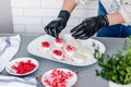 The pastry chef decorates the birds milk souffle cakes with freeze-dried raspberries and strawberries Royalty Free Stock Photo