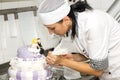 Pastry chef decorates a cake