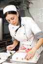 Pastry chef decorates a cake