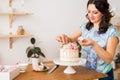 Pastry chef decorates the cake with flowers Royalty Free Stock Photo