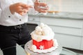 pastry chef decorates cake with powder, snow. Beautiful cake for Royalty Free Stock Photo