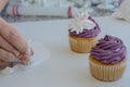 Pastry chef decorates muffins