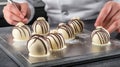 Pastry chef decorating chocolate bonbons in kitchen Royalty Free Stock Photo