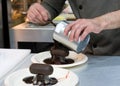 Pastry chef decorating, chef preparing desert chocolate cake Royalty Free Stock Photo