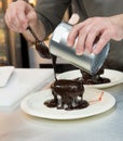 Pastry chef decorating, chef preparing desert chocolate cake Royalty Free Stock Photo