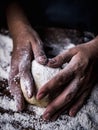 Pastry chef hand kneading Raw Dough with sprinkling white flour Royalty Free Stock Photo