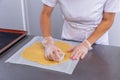 Pastry chef in the kitchen makes cookies. Cook cuts cookies from rolled dough using a cookie cutter. Master class in the kitchen. Royalty Free Stock Photo