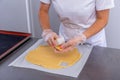 Pastry chef in the kitchen makes cookies. Cook cuts cookies from rolled dough using a cookie cutter. Master class in the kitchen. Royalty Free Stock Photo