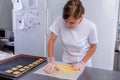 Pastry chef in the kitchen makes cookies. Cook cuts cookies from rolled dough using a cookie cutter. Master class in the kitchen. Royalty Free Stock Photo