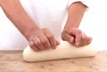 Pastry chef kneading dough on the table in front of white background Royalty Free Stock Photo