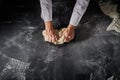 Pastry chef kneading a mound of raw dough