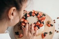 The pastry chef makes a cake at home. Delicious cream cheese cake with handmade berries. Girl learning to bake a cake Royalty Free Stock Photo