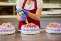 A pastry chef makes flowers from cream to decorate cakes