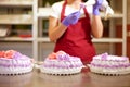 A pastry chef makes flowers from cream to decorate cakes