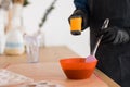 Pastry chef measures temperature of chocolate with laser thermometer