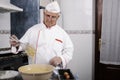 Pastry chef using a hand blender in a home kitchen Royalty Free Stock Photo