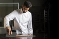 Pastry chef working on tempering chocolate on marble table