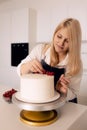 Pastry chef young caucasian woman in the kitchen