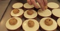 Pastry hands decorate the tops of mini tartlets.