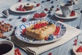 Pastry pie, tea, coffee and berries at blue rustic wood Royalty Free Stock Photo