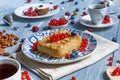 Pastry pie, tea, coffee and berries at blue rustic wood Royalty Free Stock Photo