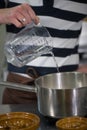 Pastry pour water into a chocolate mixture