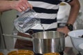 Pastry pouring water into a chocolate mixture Royalty Free Stock Photo