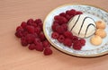 Pastry with raspberries on a white plate. Ripe berries