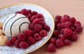 Pastry with raspberries on a white plate. Ripe berries