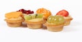 Pastry tartlets with fresh fruit isolated on white