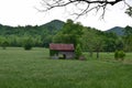 Pasture view with barn, truck, and mountains Royalty Free Stock Photo