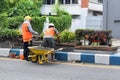 Workers repairing traffic lane dividers and separators made of concrete on asphalt roads Royalty Free Stock Photo