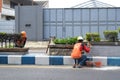 Workers repairing traffic lane dividers and separators made of concrete on asphalt roads Royalty Free Stock Photo