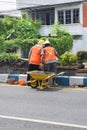 Workers repairing traffic lane dividers and separators made of concrete on asphalt roads Royalty Free Stock Photo