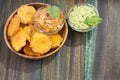 Patacon or toston fried and flattened pieces of green plantain, traditional snack or accompaniment in the Caribbean, guacamole and Royalty Free Stock Photo